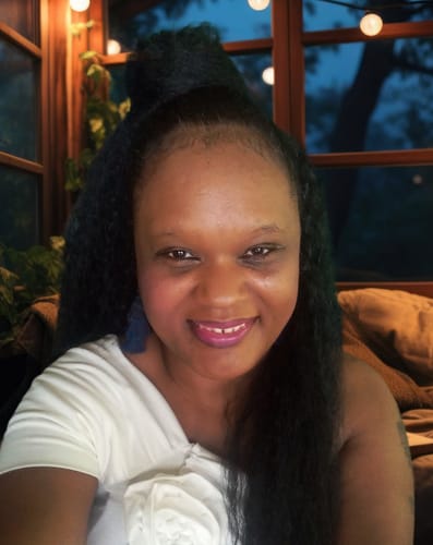 Customer smiling while wearing the long, textured Sassy & Classy Drawstring Ponytail in a high style.