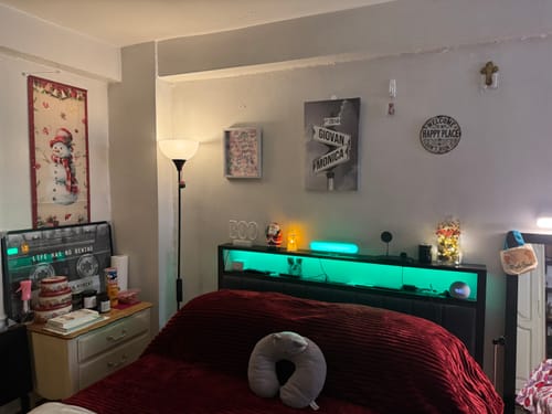 Customer's personalized COUPLES DATE OF LOVE canvas with a street sign design, hanging on a bedroom wall.