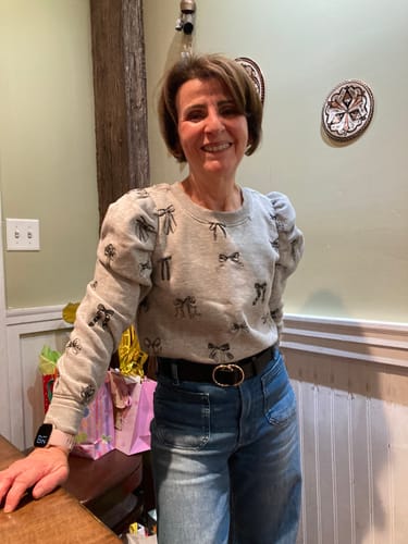 A happy reviewer showing her skin results after using the Seranova Micro Infusion System.