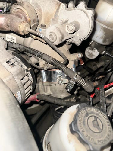 Customer's silver Glacier Diesel Heater installed in a crowded Cummins engine bay, showing the tight fit mentioned in the review.
