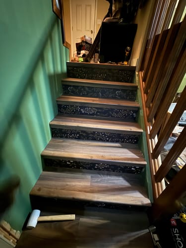 Customer's application of the patterned Roscoe Wallpaper on their wooden stair risers.