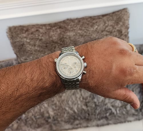 Customer wearing the Lucky Fours® Eclipse watch on their wrist, showing the silver band and light dial.