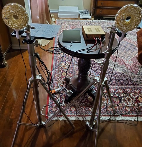 Customer's Qi Coil Max Transformation System set up at home, with two golden coils on tripods and the resonant console on a table.
