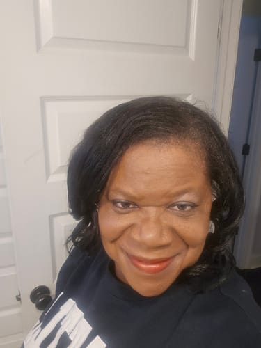 Customer showing off her silky, shiny hair after using the Healthy Hair Starter Kit.