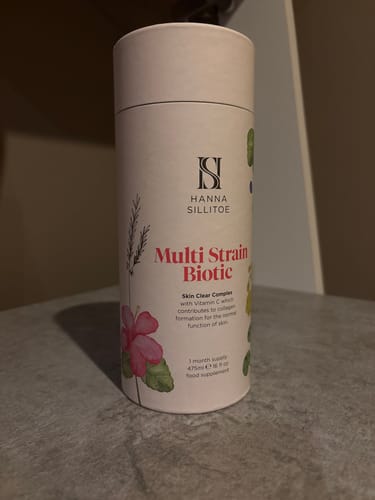 Customer's Multi Strain Biotic shown in its light pink cylindrical tube with floral illustrations.