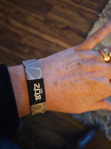 Customer wearing the gray patterned Faith Moves Mountains Bible Verse Bracelet on their wrist.