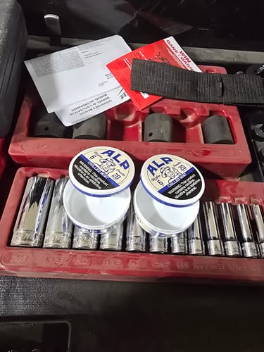 Customer's two open tins of Chilled Mint Nicotine Pouches resting in a red toolbox.