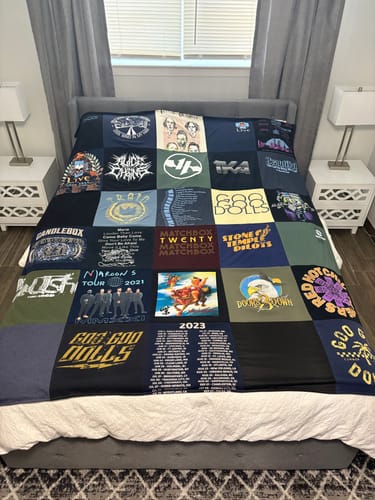 Customer's Premium T Shirt Quilt made from various band t-shirts, spread neatly across a bed.