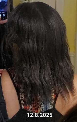 Reviewer's shoulder-length, dark hair from behind, shown as a starting point before using the BALM.