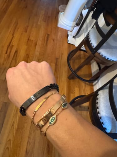 Reviewer wearing the black engraved mens chain bracelet, stacked with other bracelets on their wrist.
