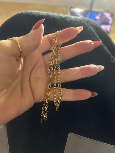 Customer holding the gold Havana Link Necklace in their hand, showing the chain's length and link detail.