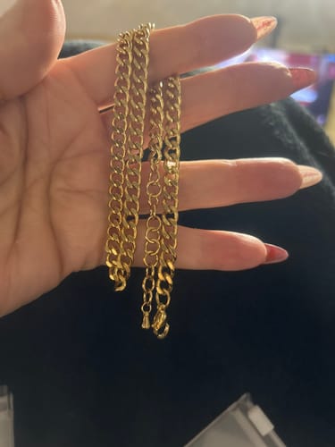 Reviewer holding the Positano Necklace bundle, showing the two gold chains and their extenders.