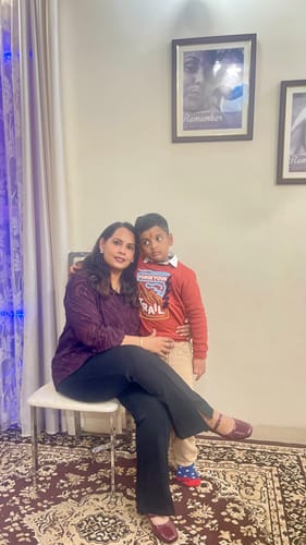Customer and a young boy sitting together for a photo.