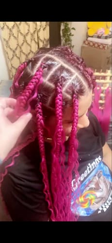 Reviewer showing neat parts and slicked edges on pink box braids, demonstrating the edge control's hold.