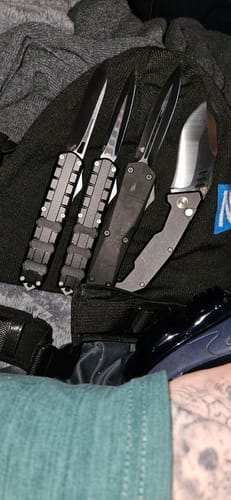 Reviewer's VT Slugger D2 Switchblade alongside three other Viper Tec knives on a dark surface.