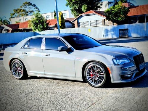Customer's grey car with shiny, clean tyres and wheels after using the Tyre Shine Kit.