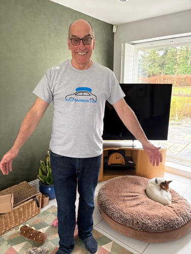Reviewer wearing the grey unisex t-shirt with a printed logo.