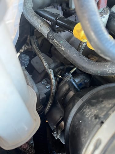 Close-up of a customer's new Cummins Stock Replacement HE300VG Turbo installed in a truck's engine bay.
