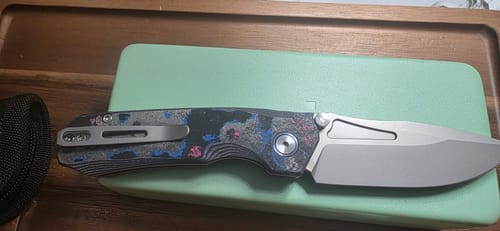 Customer's Remette Rhino knife, closed, showing the deep-carry clip over the colorful camo carbon handle.