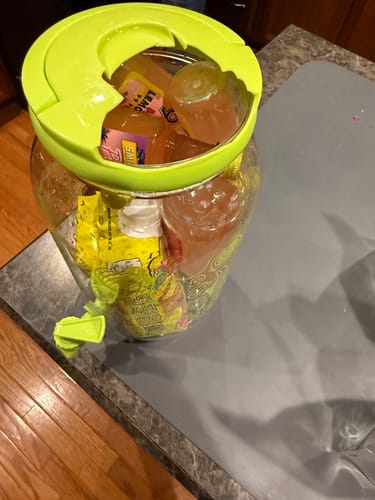 Customer's Drunk Barbie Chug Jug on a counter, showing the product arrived with a broken bright green lid.