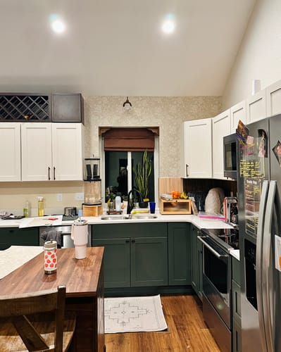 Reviewer's Bates Wallpaper with a light pattern applied as a backsplash in a farmhouse kitchen.