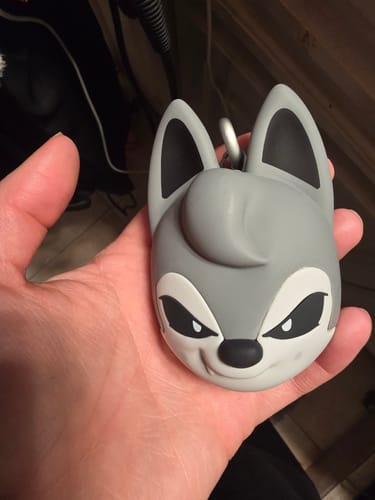Customer holding the gray, character-shaped SKZOO speaker from the STRAY KIDS album in their palm.