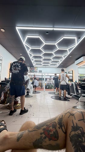 Customer's bright Hexagon LED Lights installed on the ceiling of their new barbershop, illuminating the space.