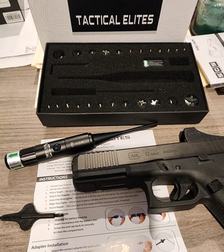 Customer's Site Right 2.0 Boresighter kit, including the case and adapters, laid out next to a handgun and instructions.