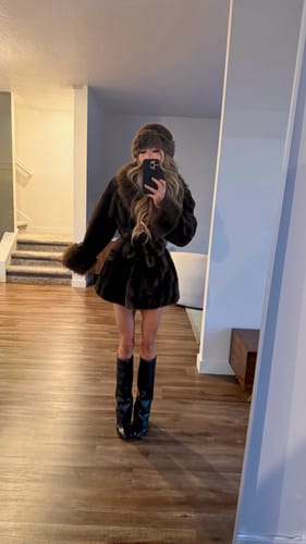 Customer models the stylish Louise Faux Fur Coat with contrasting trim in a mirror selfie.