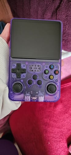 Customer holding the translucent purple RetroGame Pro console in their hand.
