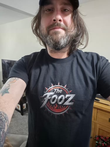 Reviewer wearing the black graphic unisex t-shirt, showing off the stretch fit.