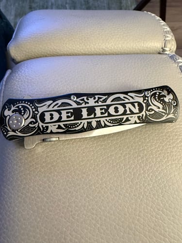Customer's black Custom Text Pocket Tool with 'DE LEON' etched on the ornate silver and black handle.