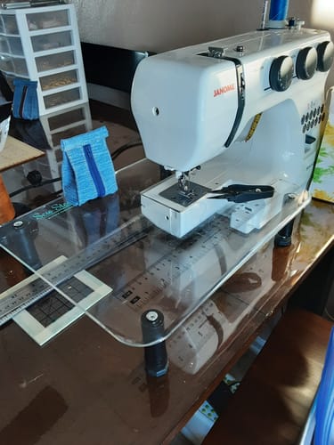 Customer's clear Sew Steady Sewing Machine Extension Table with printed rulers attached to a white Janome sewing machine on a desk.