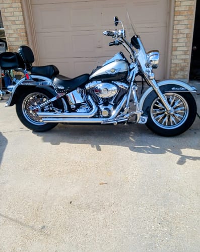 Customer's shiny motorcycle parked on a driveway after being cleaned with Flowgenix Detailing Spray.