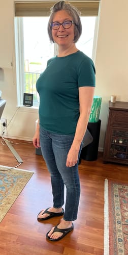 Reviewer showing the relaxed fit of the Liza Crew Neck Tee in Riverbank Green.