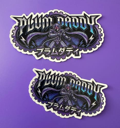 Customer's two detailed custom sample stickers with a purple 'Plum Daddy' graphic, shown in two sizes.