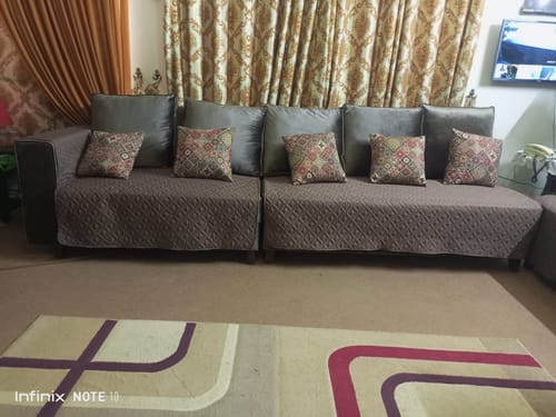 Customer's large sectional sofa fitted with the quilted brown ultrasonic sofa cover in a living room setting.
