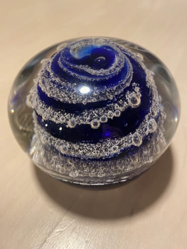 Reviewer's swirl paperweight showing the beautiful blue swirl and cremation ashes encased in clear glass.