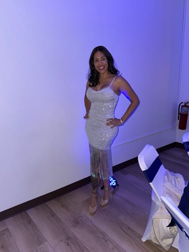 Reviewer smiling while wearing the sparkly Indie White Fringe Sequin Dress at an indoor event.