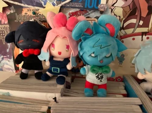 Reviewer's three colorful Alien Stage Rabbit Series plush toys displayed on a shelf.