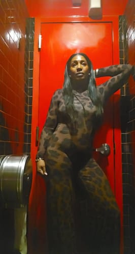 Reviewer showing the full-body fit of the long-sleeved, leopard print Naked Print Wide-Leg Jumpsuit.
