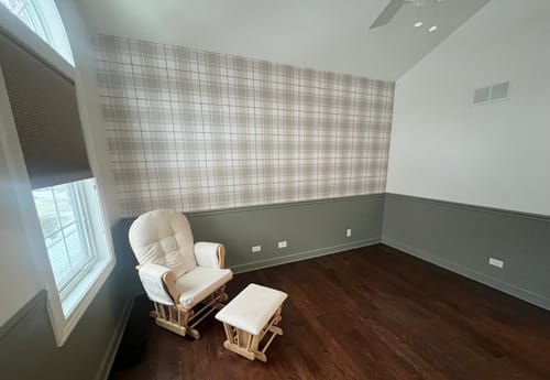 Customer's room showing the Baker Wallpaper as a plaid accent wall above grey wainscoting.