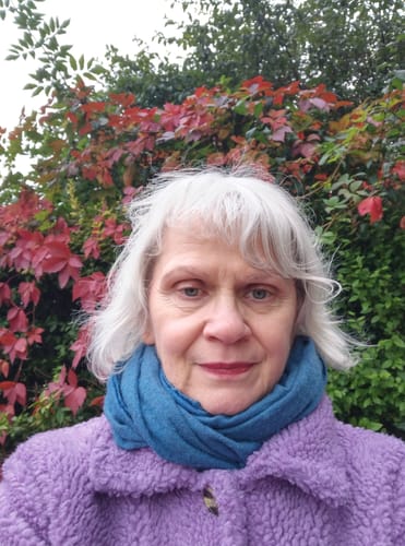 Customer showing their healthy, glowing skin in a close-up after using the Smooth Boost product.