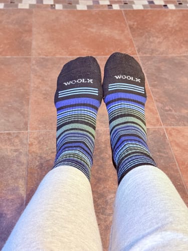 Reviewer's feet wearing the striped Everyday Crew Socks, showing the fit just above the ankle.