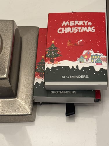 Customer's SPOTMINDERS Tracking Cards shown in their festive Christmas-themed boxes.