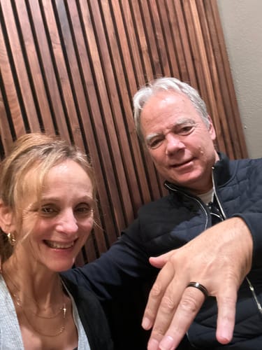 A customer's photo of a man showing off his new Black Barrel ring next to a smiling woman.