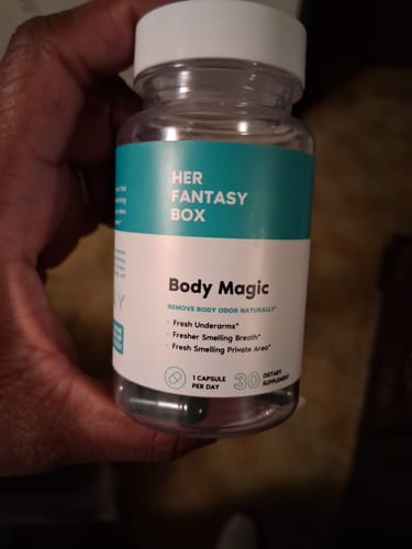 Reviewer holds a clear bottle of Body Magic Chlorophyll Pills, showing the capsules.