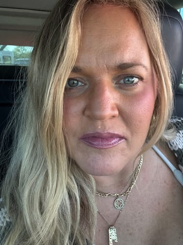 Customer in a close-up photo wearing the tinted La La Lips Moisturizing Lip Balm.