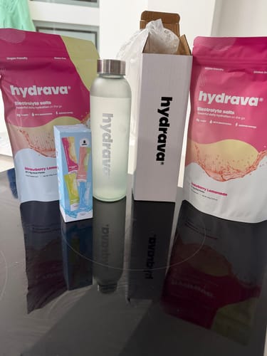 Customer's Hydrava electrolyte salts products, including two Strawberry Lemonade pouches and a branded water bottle.
