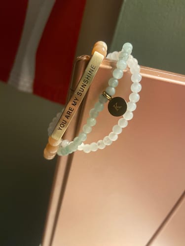 Customer's A-Z Attachable Charm with the letter 'A' on a beaded bracelet, displayed next to another bracelet.
